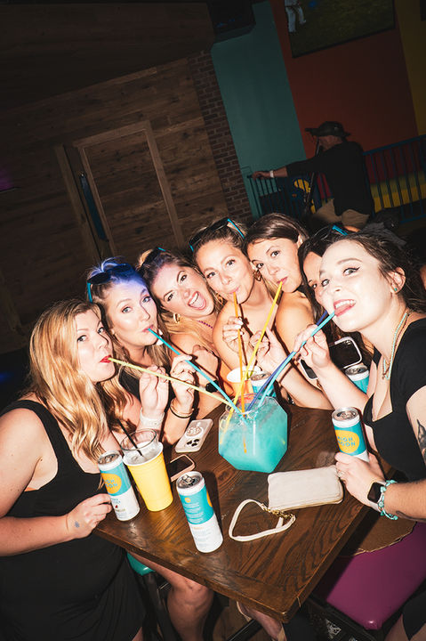 90s2k Cafe group of girls drinking from a party bowl