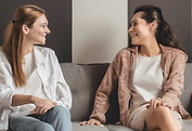 two people talking sitting down in a roo