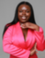 Kheri-Ann director of Dear Women posing for a picture in a pink suit.