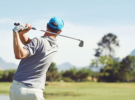 Golfer hitting golf