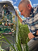 Technician inspecting complex electrical control panel outdoors