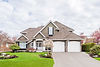 Two-story suburban home with a two-car garage and green lawn