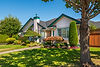 Single-story home with manicured lawn and garden.