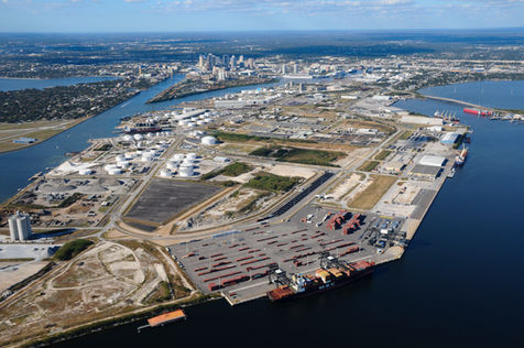 Shipping port with containers and city skyline