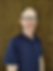 Smiling man with glasses in a blue polo shirt