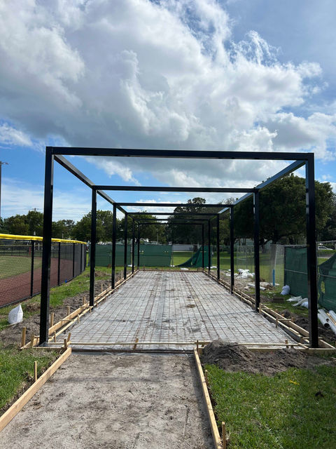 Open black metal frame structure on concrete outdoors