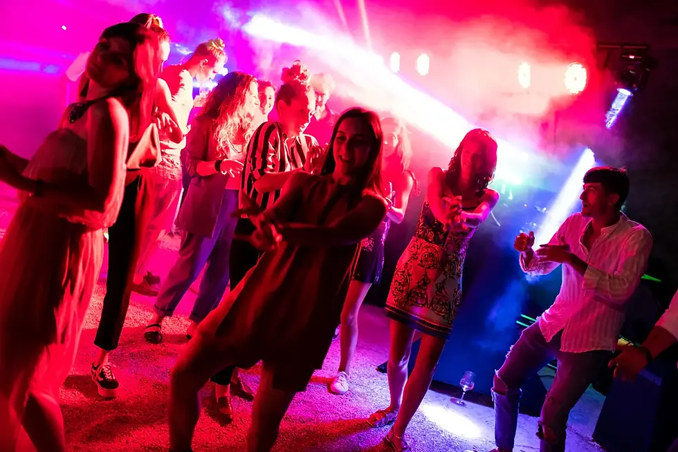 High-energy party in Italy with guests dancing and synchronized DJ lights