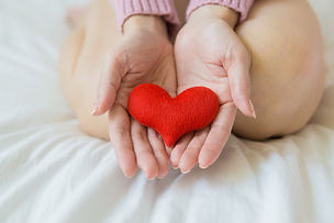 hands holding a stuffed heart