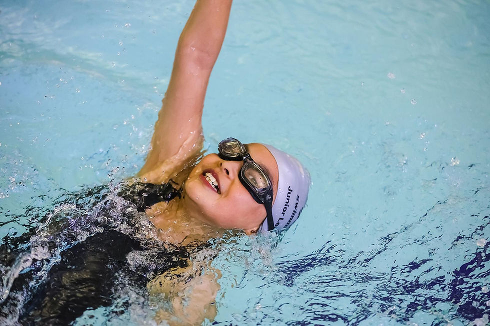 A child performing backstroke in a swimming pool
