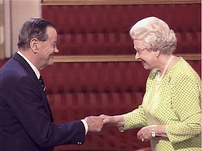 An older man receiving an MBE from Queen Elizabeth II