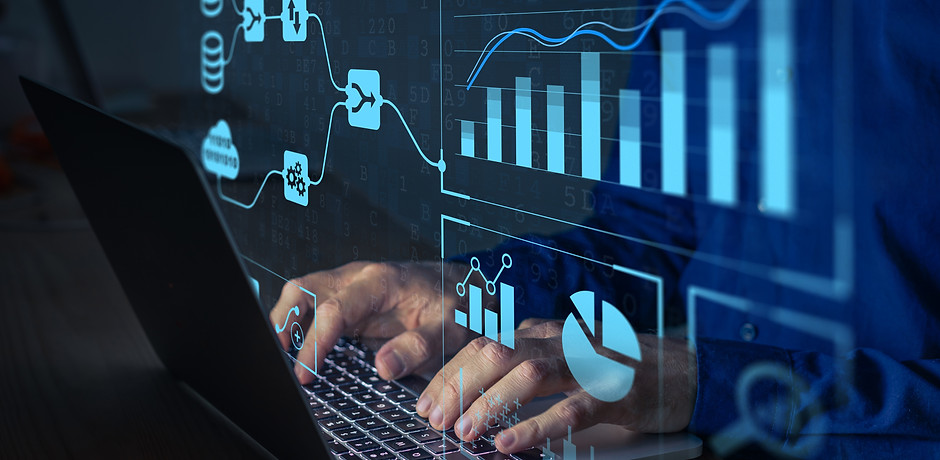 Analyst working with Business Analytics and Data Management System on computer to make rep