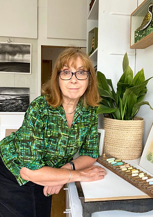 Yorkshire Artist Angie Rogers photographed in her artist's studio in Linden mill, wearing vintage green shirt.
