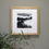 Thumbnail: A black and white snow scene with winter trees in a pale wooden frame on grey wall.