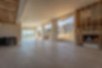 Interior building project with large windows and mountain view