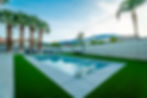 Swimming pool with palm trees and artificial turf