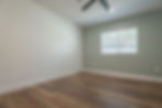 Empty room with wood floor and light green accent wall