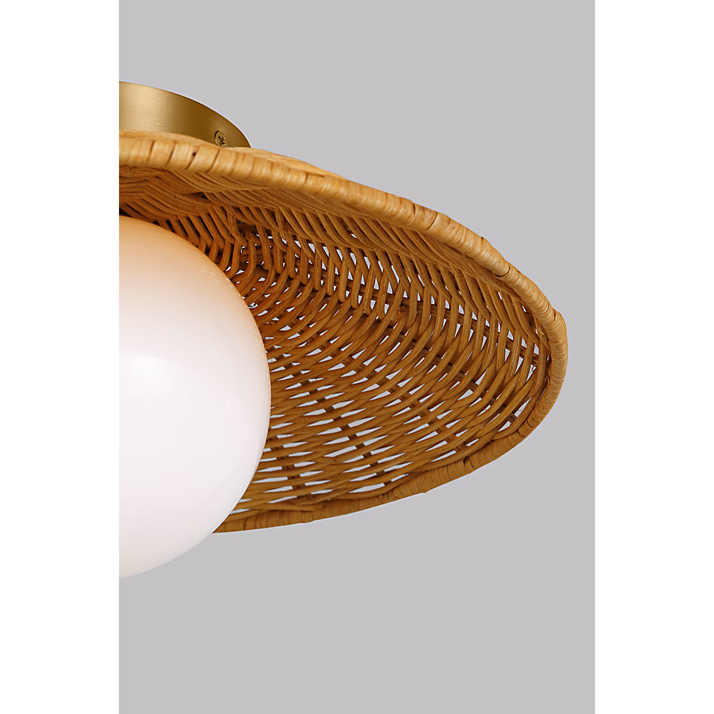 Handwoven rattan shade with a soft milk glass orb