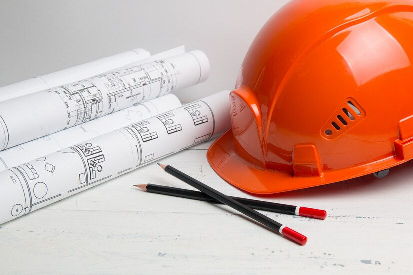 engineering-house-drawings-helmet-pencils-blueprints_113913-379.jpg