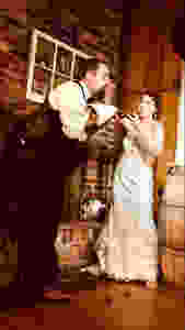 Bride smashing wedding cake in Grooms face