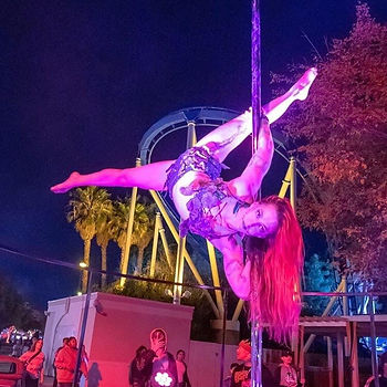 Jody performing a pegasus split on a pole at CA's Great America