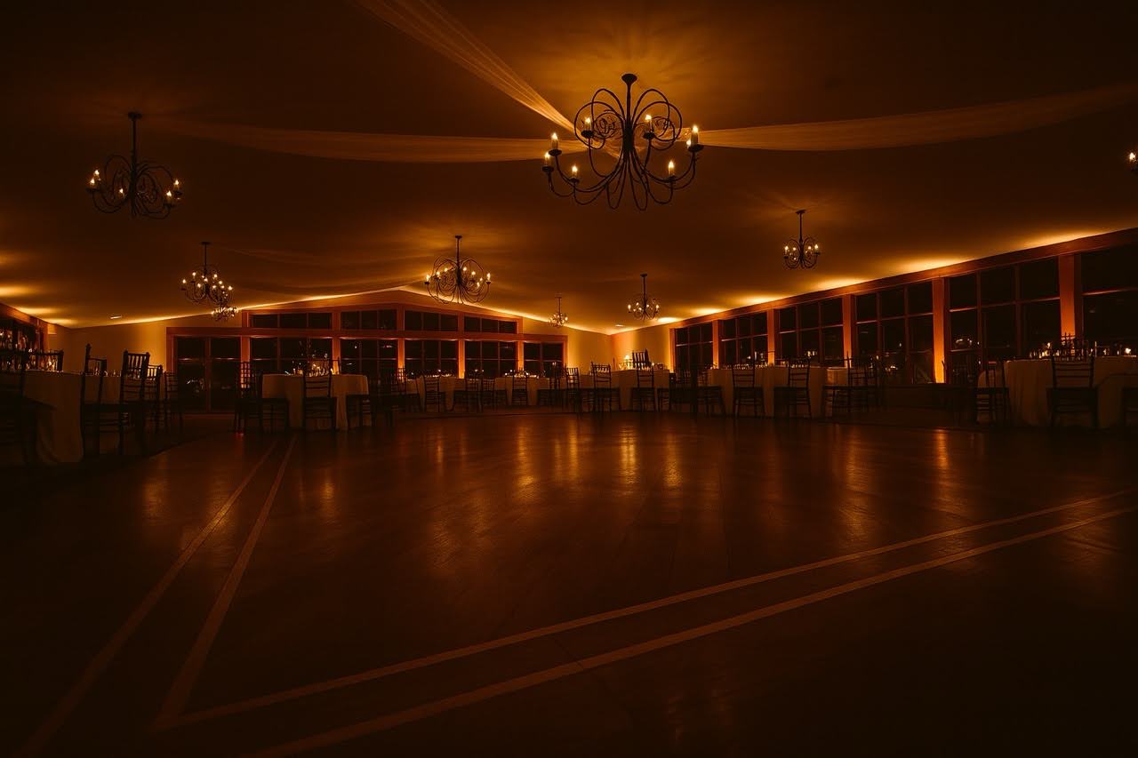 Amber uplighting transforming a New Jersey wedding venue ballroom with warm color wash on walls and columns