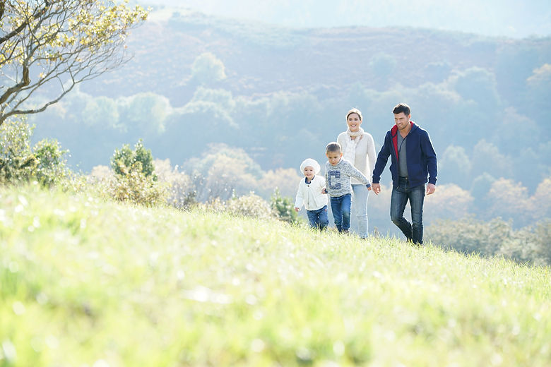 Happy family walking in countryside.jpeg