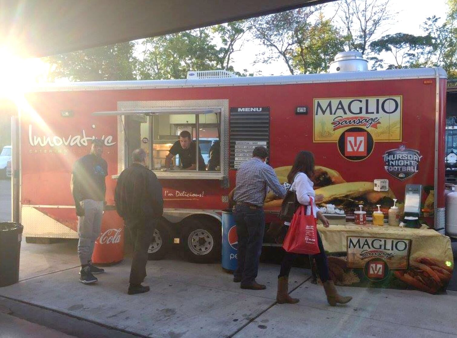 Food truck serving gourmet sliders, tacos and bowls