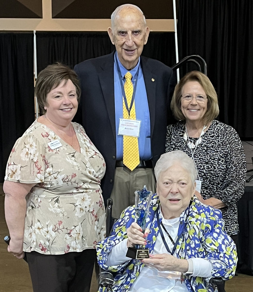 Rosalee Sites proudly holds an award alongside Angie Gwaltney (left), Kathy Whitaker (right), and her husband Bruce Sites