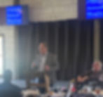 Executive Director Mike Harrison speaks at the FTDD 59th Annual Meeting, engaging attendees from the podium.