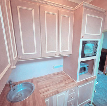 A custom made kitchen designed to maximise a very tight space. MDF units with a real hardwood worktop, ready for the client to paint.
