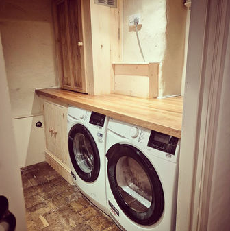 A small utility room to house a boiler and appliances and to box in and cover pipes and wiring. Finished with a real hardwood countertop.