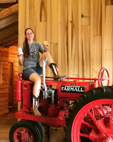 Founder of Tin Barn Brewing Enjoying a Cold One on a Tractor