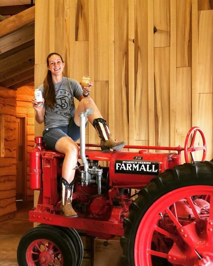 Founder of Tin Barn Brewing Enjoying a Cold One on a Tractor