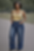 Woman Wearing Gold Shirt with Pre-Washed Baggy jeans with Gold Chain Accent
