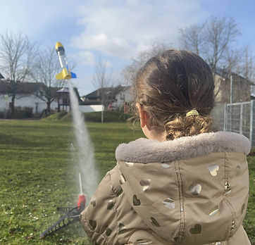 A water rocket launch observed by a girl