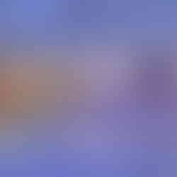 Event hall with stone accent walls, wood-style flooring, and a small raised stage. The space has drop ceiling panels with recessed lighting, wall-mounted flat-screen monitors, and colored accent lighting that casts blue and purple tones across the floor and walls.