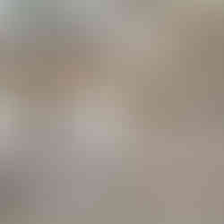 Unfinished basement with concrete floor and exposed insulation, ductwork, and beams; HVAC equipment and a water heater sit along the right wall beside a small framed partition.