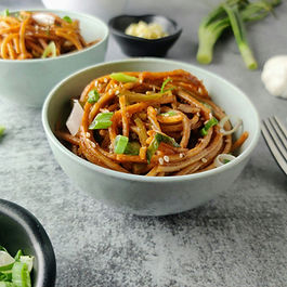 1. Cook noodles according to package directions and drain
2. Julienne the carrot and bell pepper
3. Heat a small amount of oil in a wok and stir-fry vegetables for 3–4 minutes
4. In a bowl, mix peanut butter and soy sauce with a splash of warm water to make a smooth sauce
5. Add cooked noodles to the wok and pour in the sauce
6. Toss until everything is evenly coated and heated
7. Serve warm, garnished with crushed peanuts or cilantro