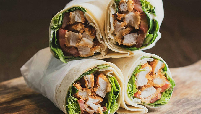 1. Heat oil in a pan. Add chicken strips, salt, and pepper. Cook 5–7 minutes.
2. Add mustard and honey and coat chicken; cook 1 additional minute.
3. Fill tortilla with greens, chicken, and optional add-ins.
4. Roll and eat.