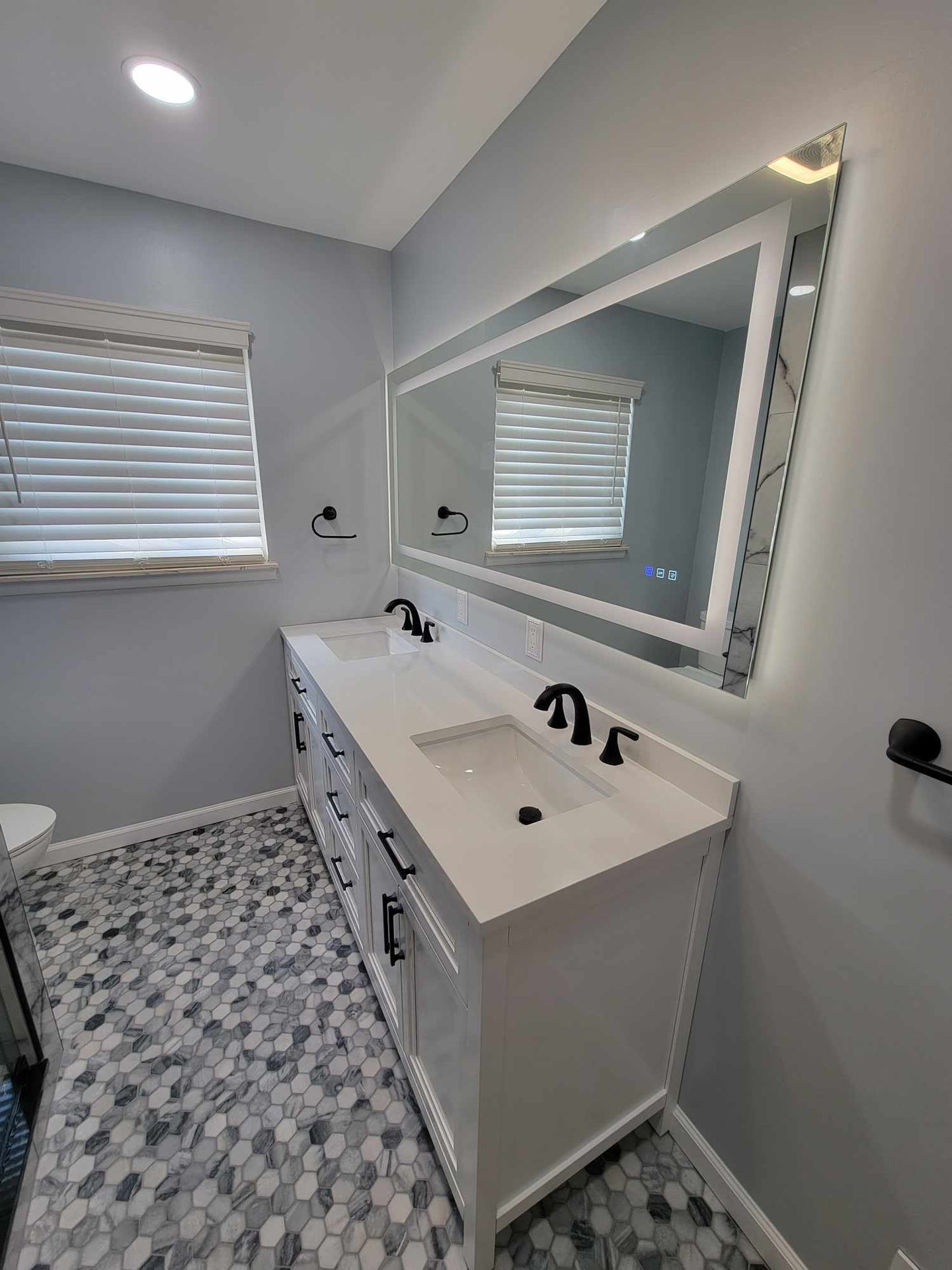 a bathroom with two sinks and a large mirror