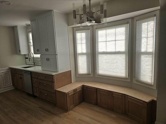 "Livingston County kitchen remodel featuring two-tone cabinetry with white uppers and natural wood lowers, subway tile backsp