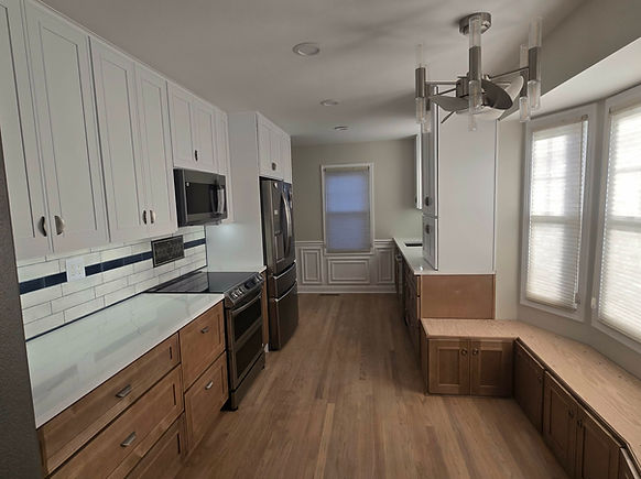"Livingston County kitchen remodel featuring two-tone cabinetry with white uppers and natural wood lowers, subway tile backsp