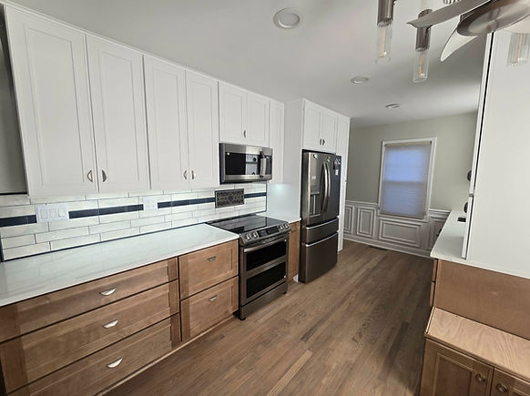 "Livingston County kitchen remodel featuring two-tone cabinetry with white uppers and natural wood lowers, subway tile backsp