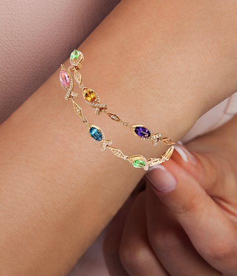 Gold bracelet featuring multicolored marquise-cut gemstones set in Christian Ichthys fish symbols