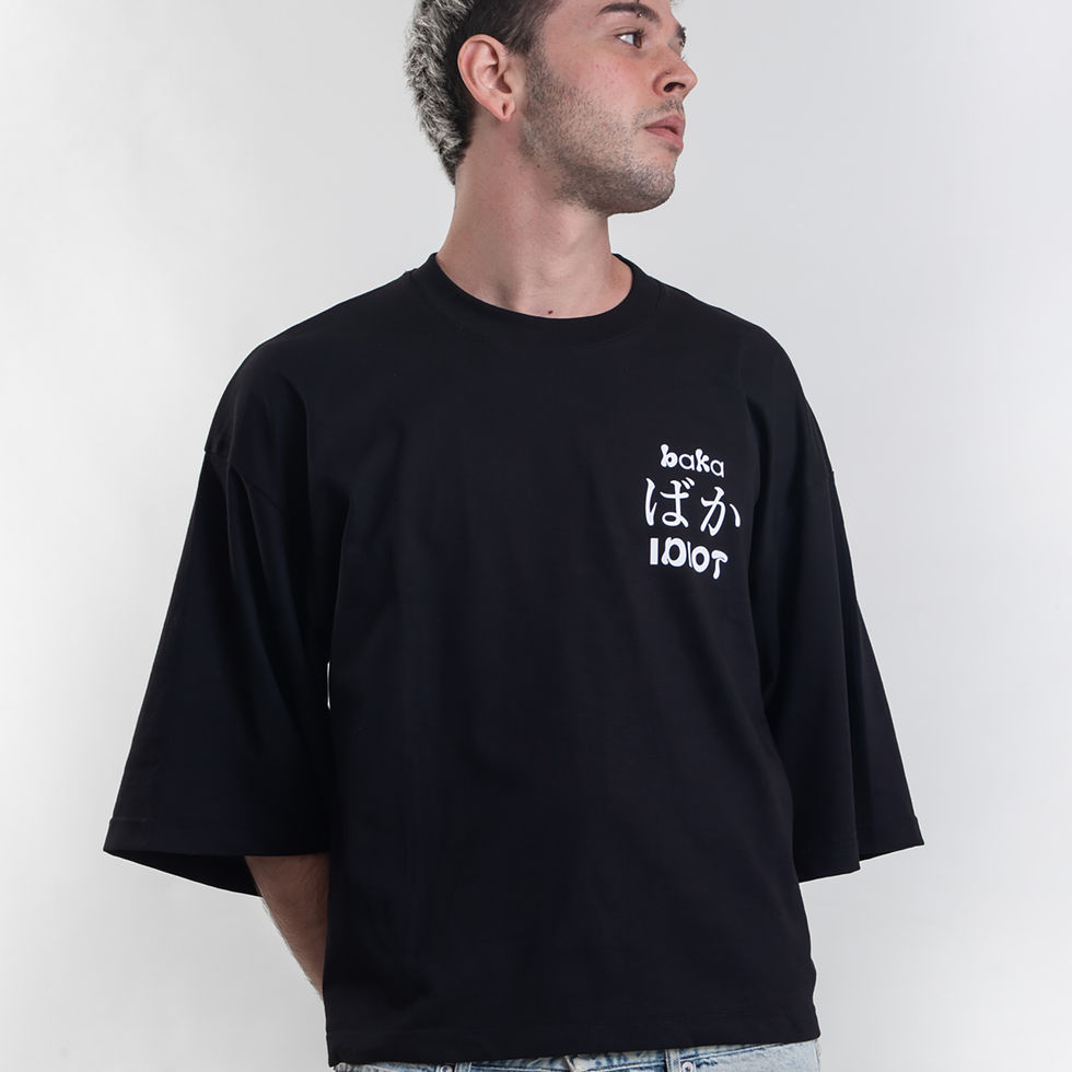 BAKA black boxy T-shirt worn by male model, standing pose showing front graphic