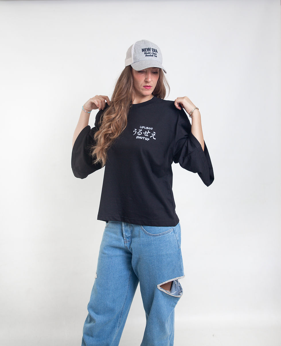Female model wearing black URUSEE boxy graphic streetwear T-shirt, front view.