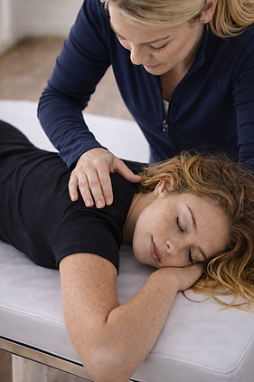 Woman getting chiropractic for neck pain.png