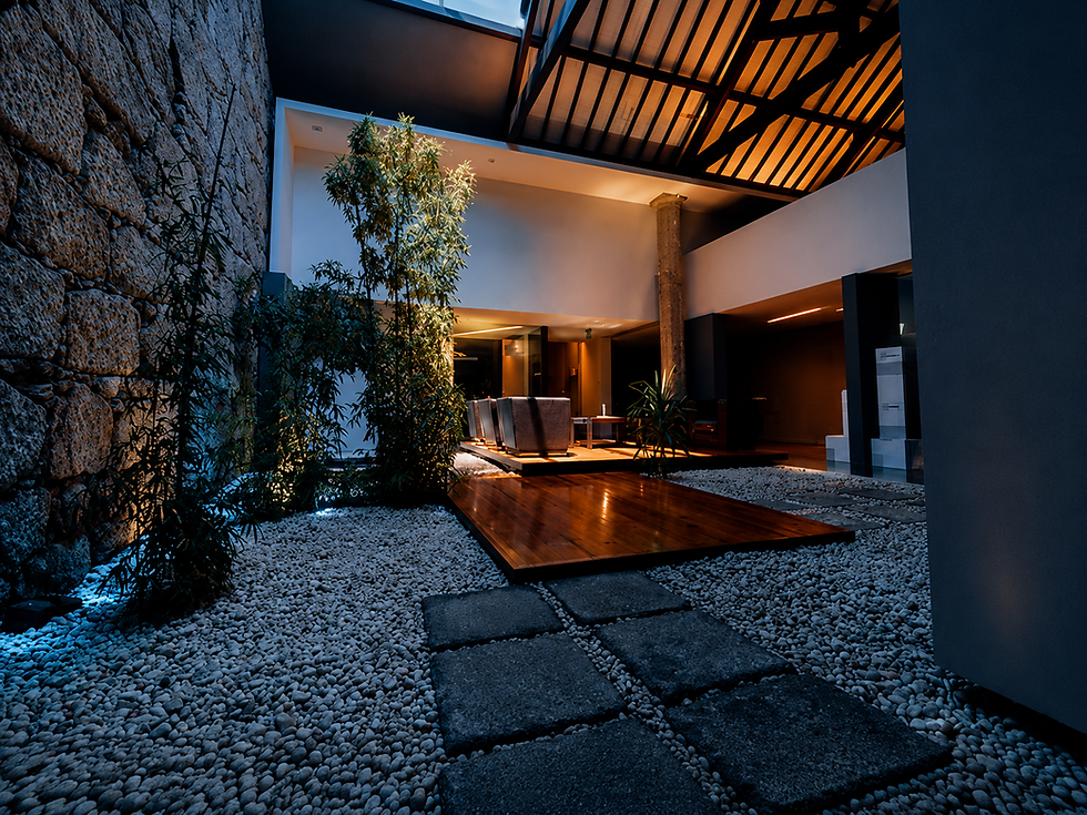 Interior view of the ARMIS office with landscaped areas, stone walls, wooden walkways, and collaborative spaces.