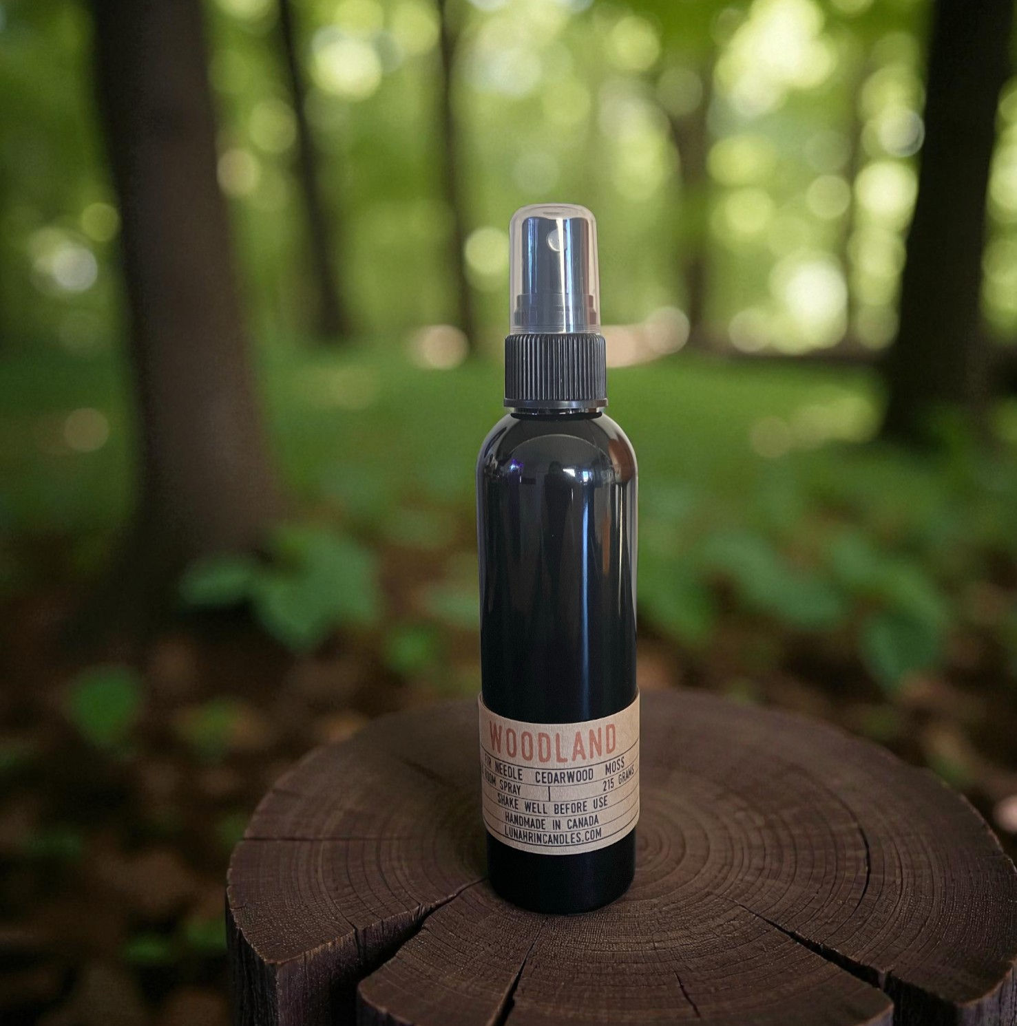 Woodland room spray in a black plastic bottle, part of the Lunahrin fundraiser collection, flame-free and woodsy.