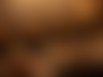 Six crockpots of soup on a kitchen counter with ladles, a six-cup muffin tin filled with different soups, buns, toppings, and warm candlelight